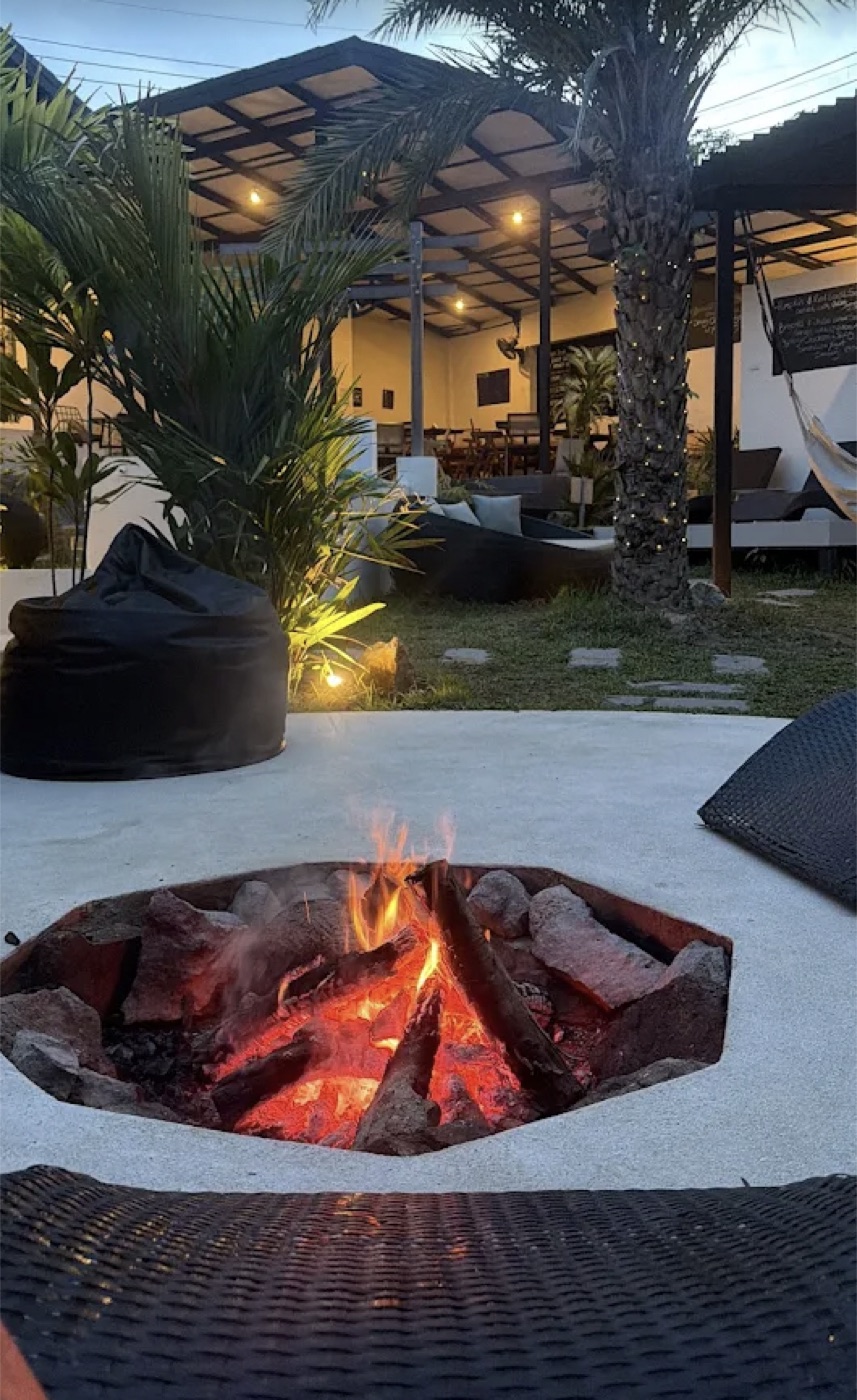 Open-air tropical lounge and firepit at the retreat setting
